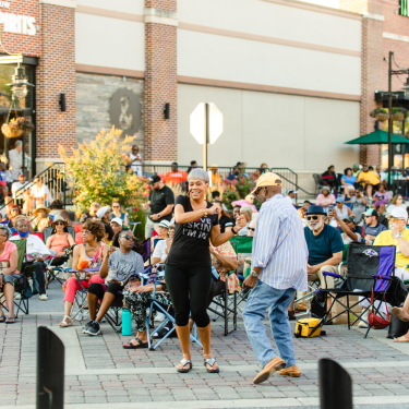 People dancing and watching at an outdoor event