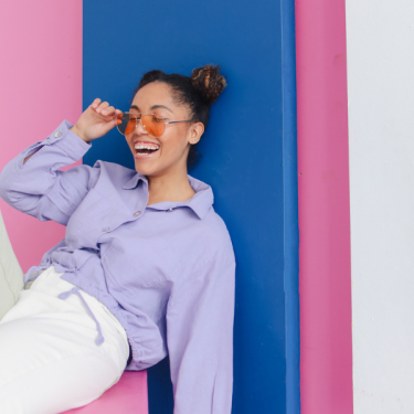 Girl Showing Sunglasses and laughing